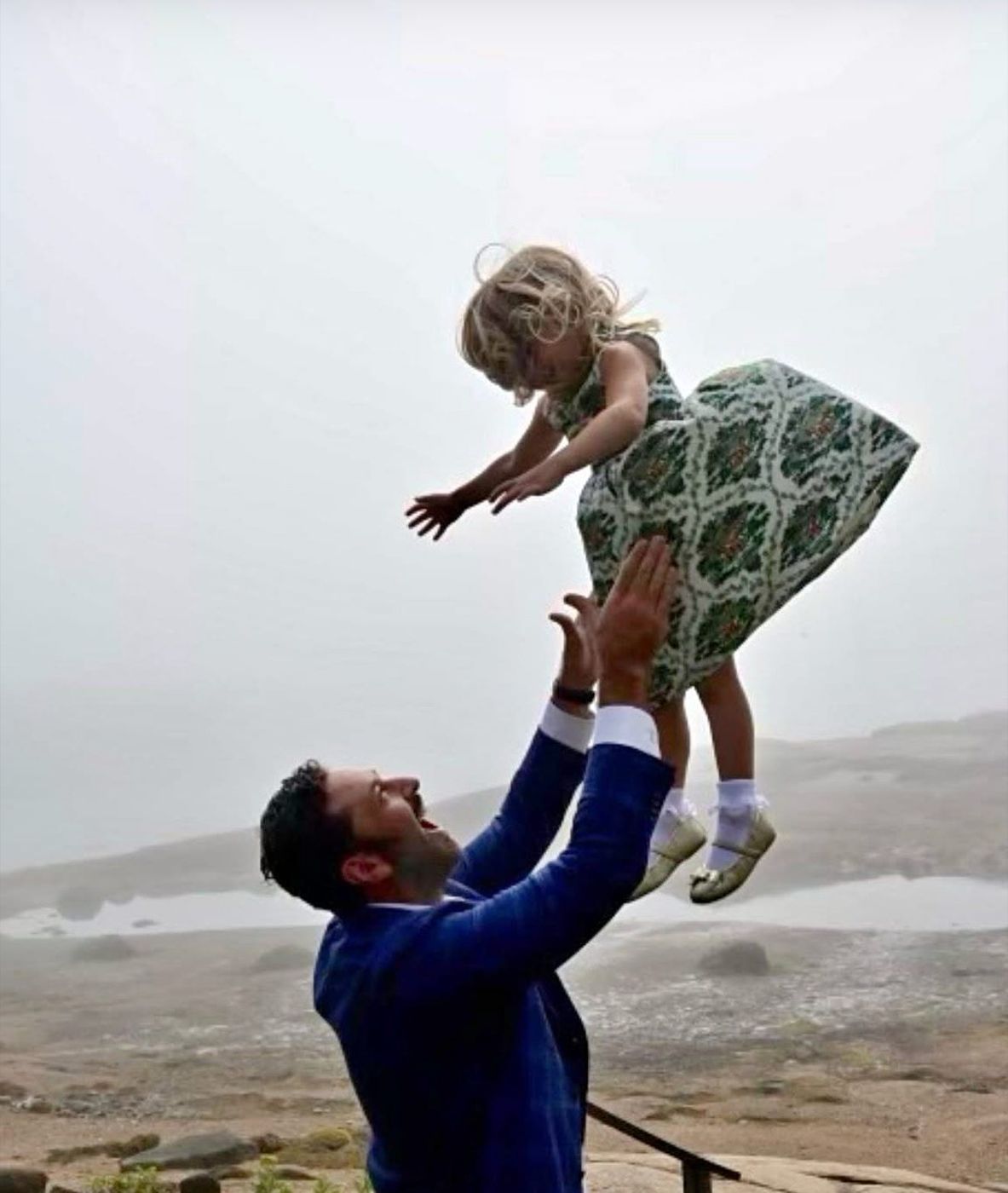 Ted tossing his daughter into the air